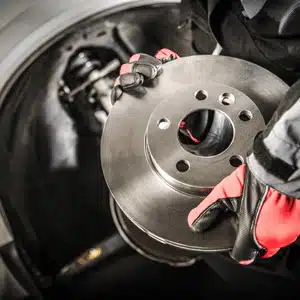 Specialist prepares to install a rotor, ensuring compatibility with Mercedes brake pads system