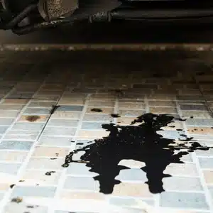 An oil puddle under the car suggests a possible engine or gasket issue