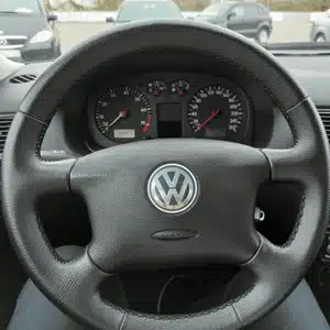 The Volkswagen steering wheel and dashboard gauges offer a clear and simple driving interface