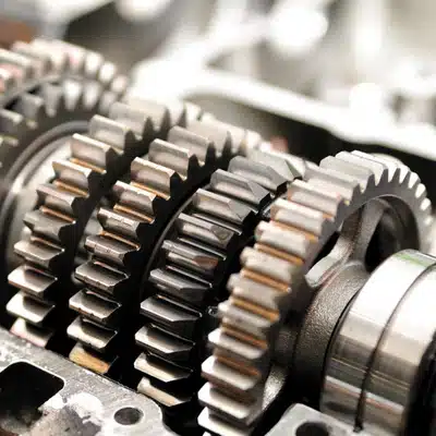 Close-up view of shiny transmission gears inside a car engine, illustrating durability linked to how long do MINI Coopers last