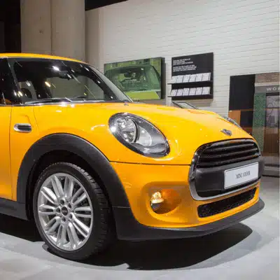 Yellow Mini Cooper displayed while owner learns about mini cooper coolant type and change schedule