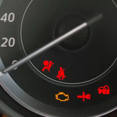 Dashboard close-up displaying multiple warning icons, indicating diagnostics needed at euro auto repair service center